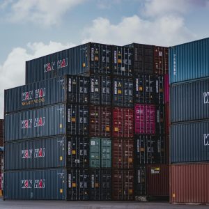 High vertical stack of cargo containers at a port, symbolizing global logistics.