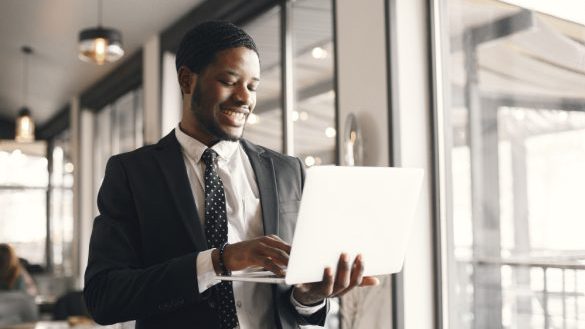 african usinessman using laptop cafe
