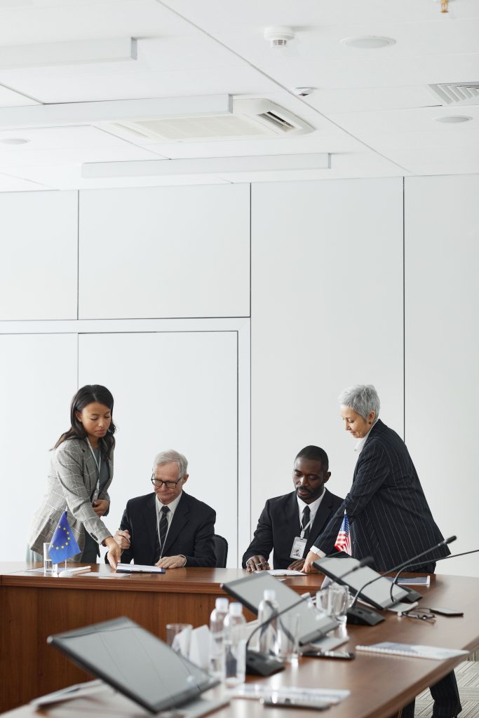 Business professionals engage in a collaborative meeting in a modern office setting.